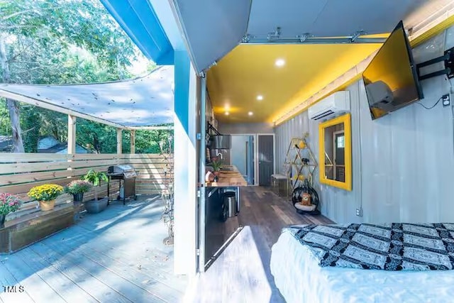 view of patio with a balcony, a grill, and a wall mounted AC