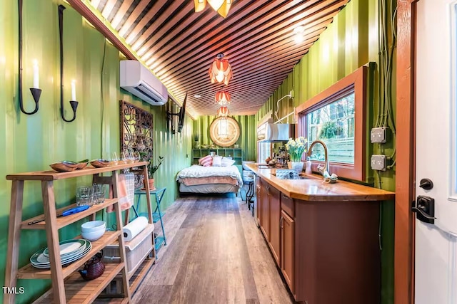 bathroom featuring an AC wall unit, vanity, and wood finished floors