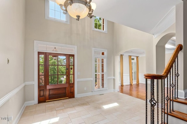 405 Silver Creek Trl, Chapel Hill, NC 27514 - foyer featuring a high ceiling, a chandelier, arched walkways, and stairway