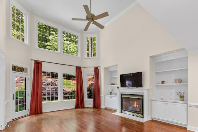 405 Silver Creek Trl, Chapel Hill, NC 27514 - unfurnished living room featuring a high ceiling, a fireplace with flush hearth, crown molding, a ceiling fan, and built in shelves