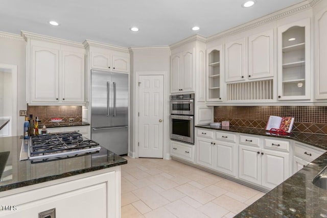405 Silver Creek Trl, Chapel Hill, NC 27514 - kitchen with appliances with stainless steel finishes, glass insert cabinets, backsplash, dark stone countertops, and recessed lighting