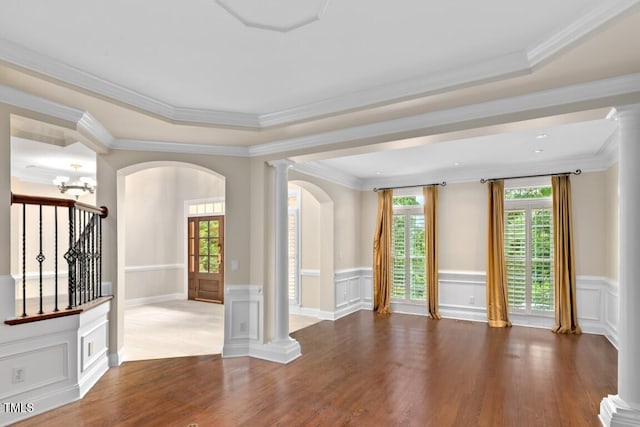 405 Silver Creek Trl, Chapel Hill, NC 27514 - empty room with arched walkways, wood finished floors, healthy amount of natural light, a wainscoted wall, and ornate columns