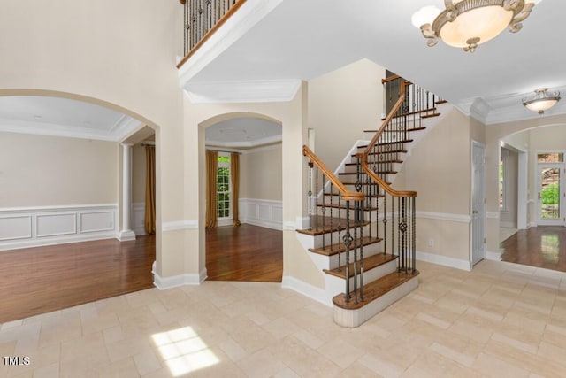 405 Silver Creek Trl, Chapel Hill, NC 27514 - foyer entrance with arched walkways, crown molding, stairs, wood finished floors, and wainscoting