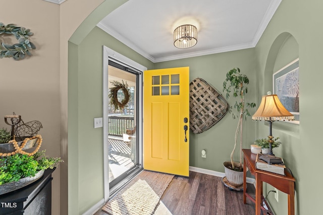 entrance foyer with baseboards, arched walkways, wood finished floors, and crown molding