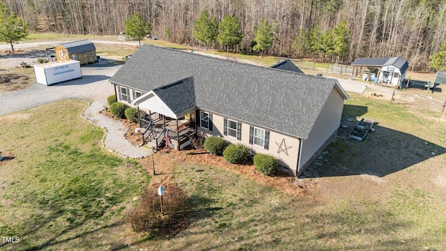 bird's eye view with a wooded view