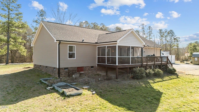 rear view of house featuring crawl space, a lawn, roof with shingles, and a sunroom