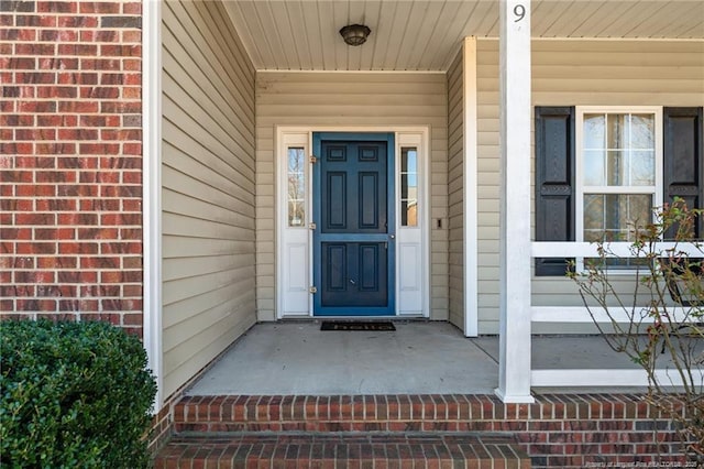 property entrance featuring brick siding