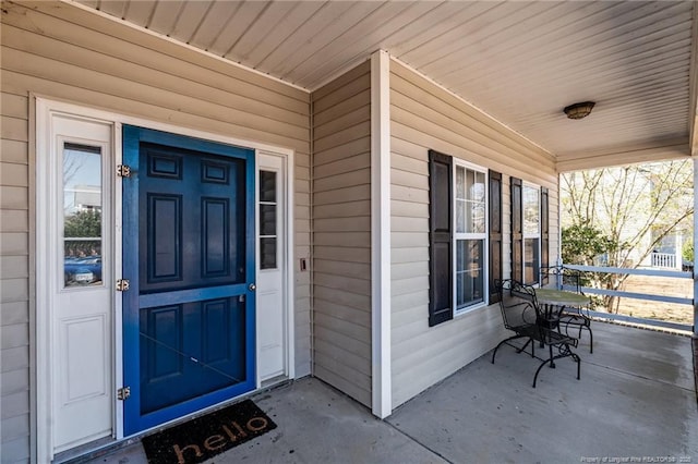 view of exterior entry with a porch