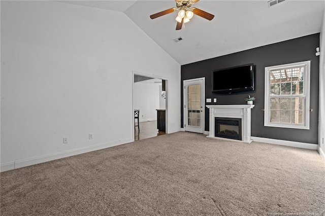 unfurnished living room featuring high vaulted ceiling, a fireplace with raised hearth, carpet flooring, baseboards, and ceiling fan