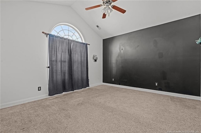 carpeted spare room with high vaulted ceiling, baseboards, visible vents, and ceiling fan