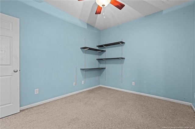 spare room with a ceiling fan, baseboards, and carpet floors