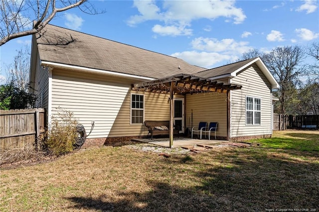 rear view of property featuring a patio area, a lawn, a pergola, and fence