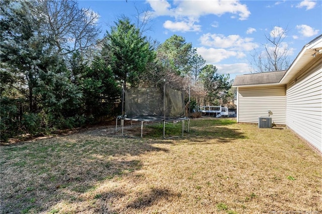 view of yard with cooling unit and a trampoline