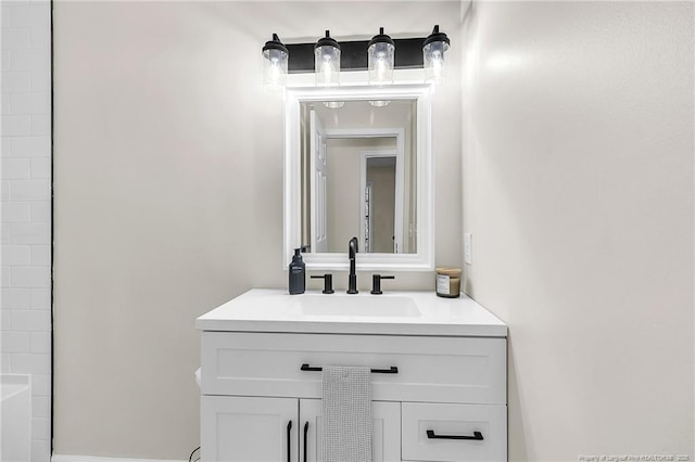 bathroom with vanity and a washtub