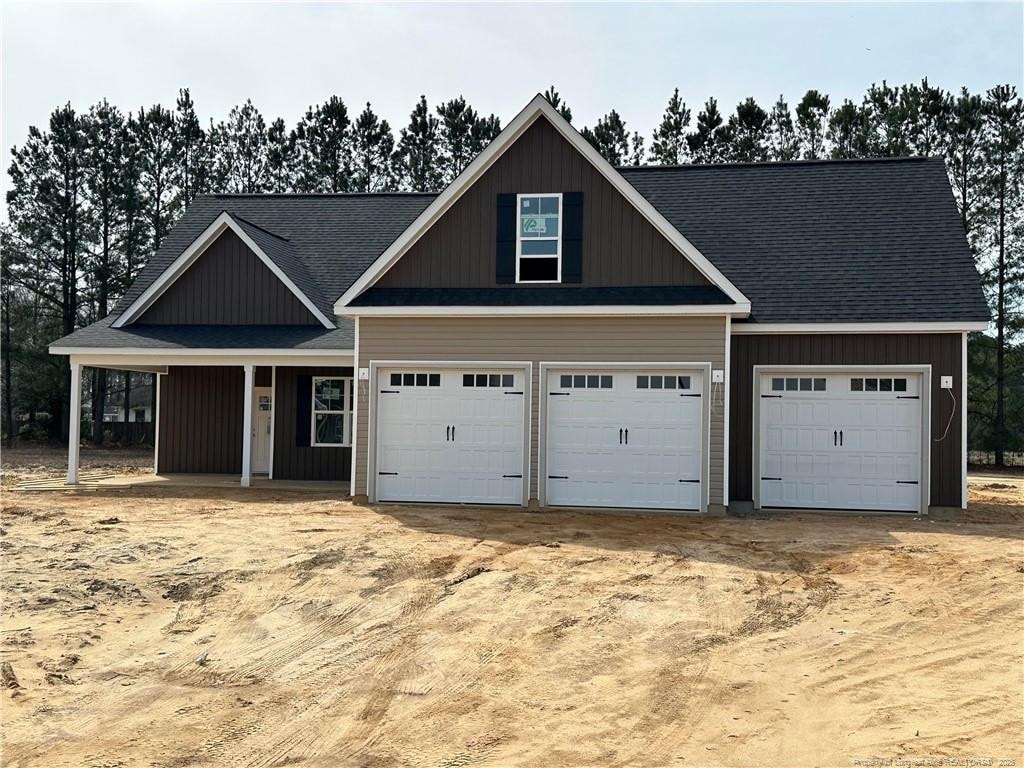 craftsman-style home with board and batten siding and driveway