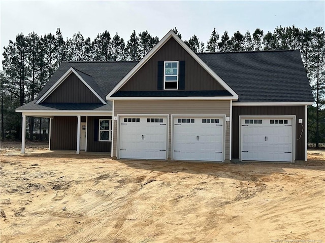 craftsman-style home with board and batten siding and driveway