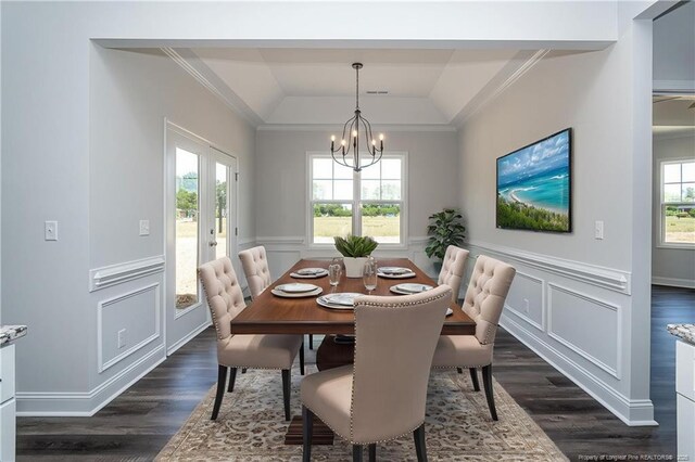 5814 James Allen Ln, Stedman, NC 28391 - dining area with a chandelier, dark wood-style flooring, crown molding, a wainscoted wall, and lofted ceiling
