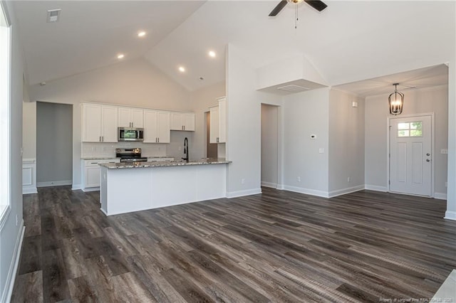 5814 James Allen Ln, Stedman, NC 28391 - kitchen with appliances with stainless steel finishes, white cabinetry, a peninsula, light stone counters, and open floor plan