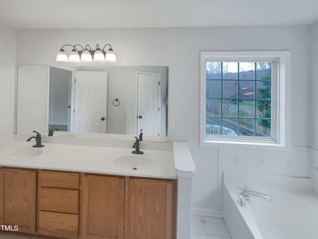 full bathroom with tile patterned flooring, a garden tub, double vanity, and a sink