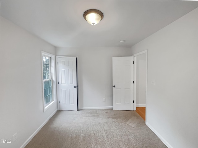 unfurnished bedroom featuring baseboards and carpet flooring