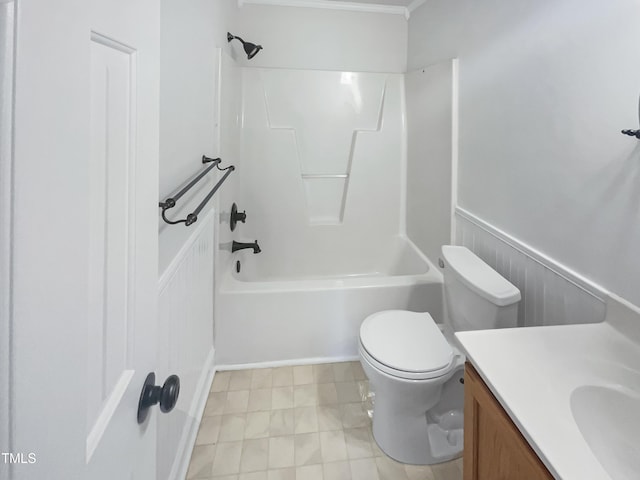 bathroom with shower / bathtub combination, toilet, wainscoting, and vanity