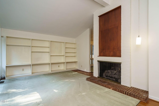 unfurnished living room with a fireplace, baseboards, and lofted ceiling