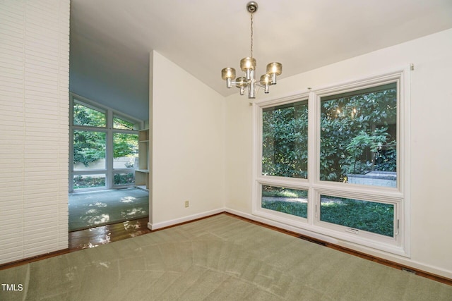 spare room featuring baseboards, an inviting chandelier, and vaulted ceiling