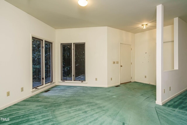 empty room with baseboards and carpet floors