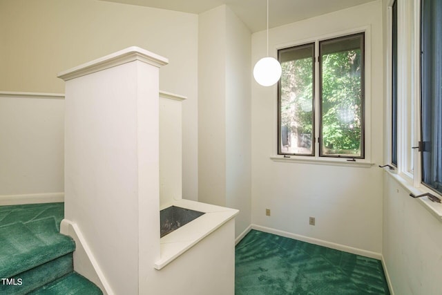 interior space with carpet flooring and baseboards