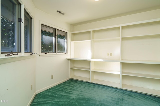 carpeted empty room with visible vents and baseboards