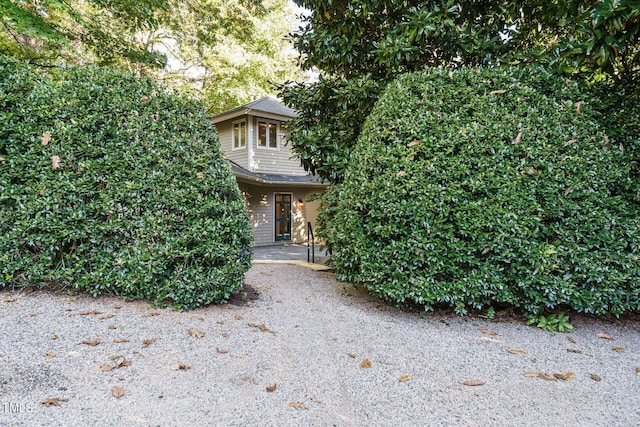 view of property hidden behind natural elements