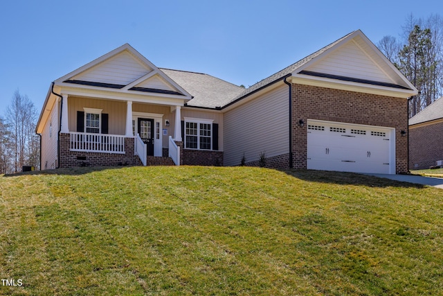 view of front facade with covered porch, concrete driveway, a front yard, a garage, and brick siding