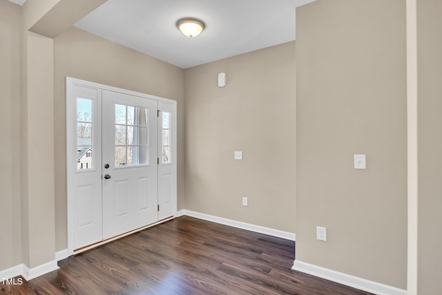 foyer featuring baseboards and dark wood finished floors