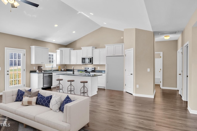 living room featuring visible vents, baseboards, dark wood finished floors, recessed lighting, and a ceiling fan