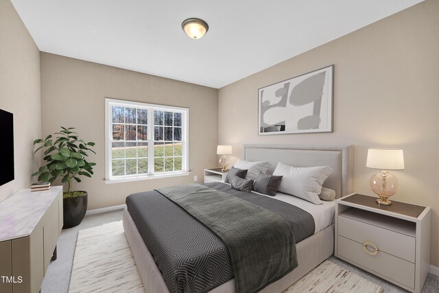 bedroom featuring baseboards and light carpet