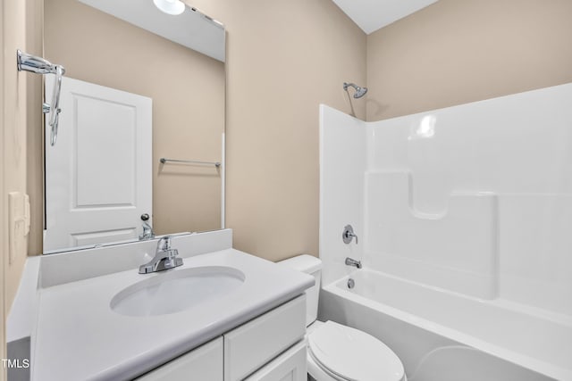 bathroom with vanity, shower / bathing tub combination, and toilet