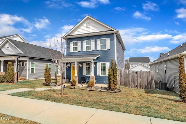 view of front of house featuring central AC unit, a porch, a front yard, and fence