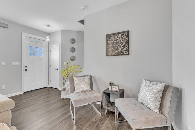 entryway with baseboards and wood finished floors