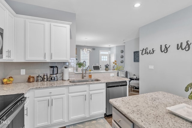 kitchen with dishwasher, white cabinets, backsplash, and a sink