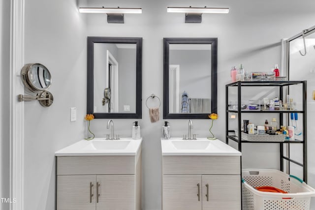 bathroom featuring two vanities and a sink