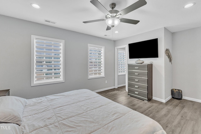 bedroom featuring visible vents, recessed lighting, baseboards, and wood finished floors