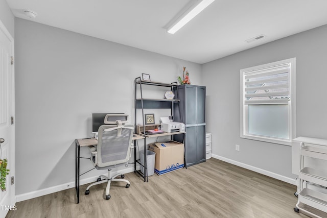 office featuring light wood-style flooring, baseboards, and visible vents