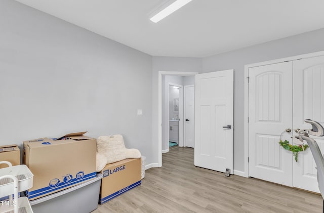 sitting room with light wood-style flooring and baseboards