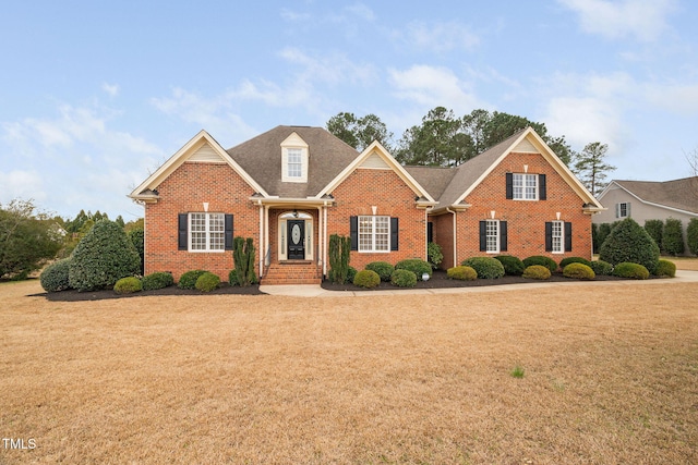 view of front of house featuring a front lawn and brick siding