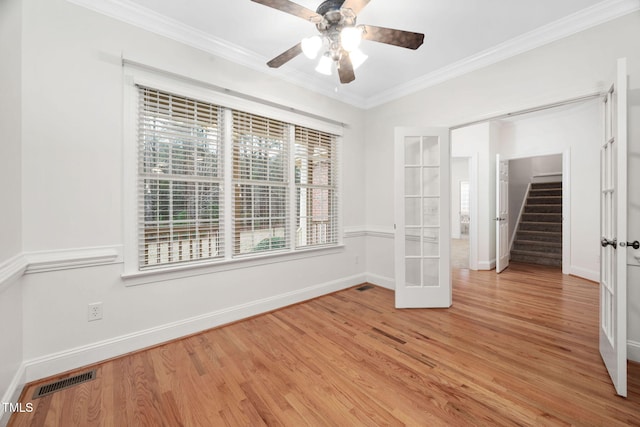 unfurnished room featuring visible vents, a healthy amount of sunlight, light wood-style flooring, and crown molding