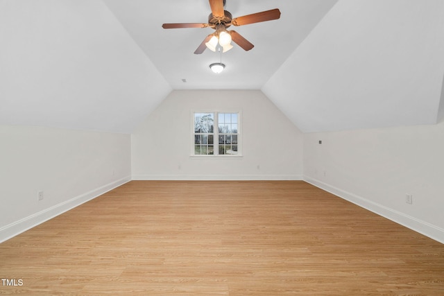 bonus room featuring baseboards, light wood-style flooring, a ceiling fan, and vaulted ceiling