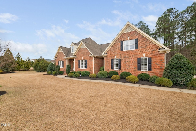 traditional home with brick siding and a front yard