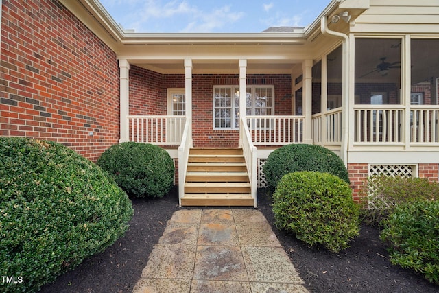 view of exterior entry with brick siding