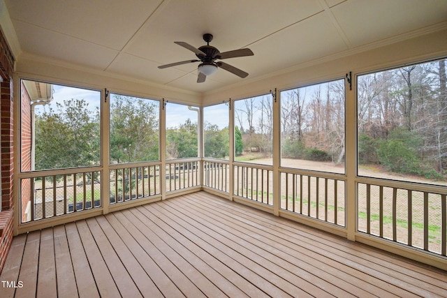 unfurnished sunroom featuring plenty of natural light and a ceiling fan