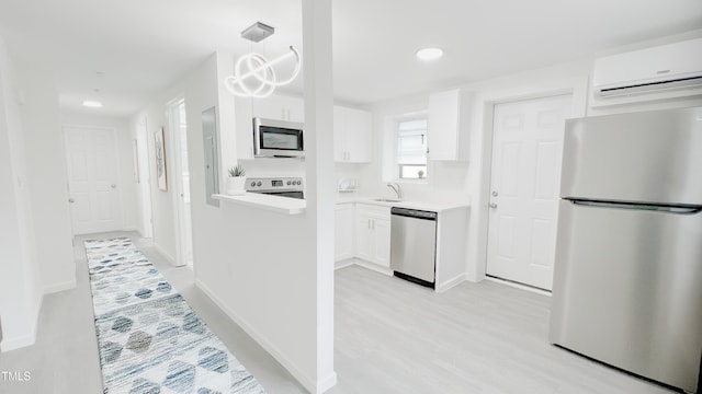 800 Pritchard Avenue Extension Unit H3, Chapel Hill, NC 27516 - kitchen featuring appliances with stainless steel finishes, a wall mounted air conditioner, white cabinetry, light countertops, and recessed lighting